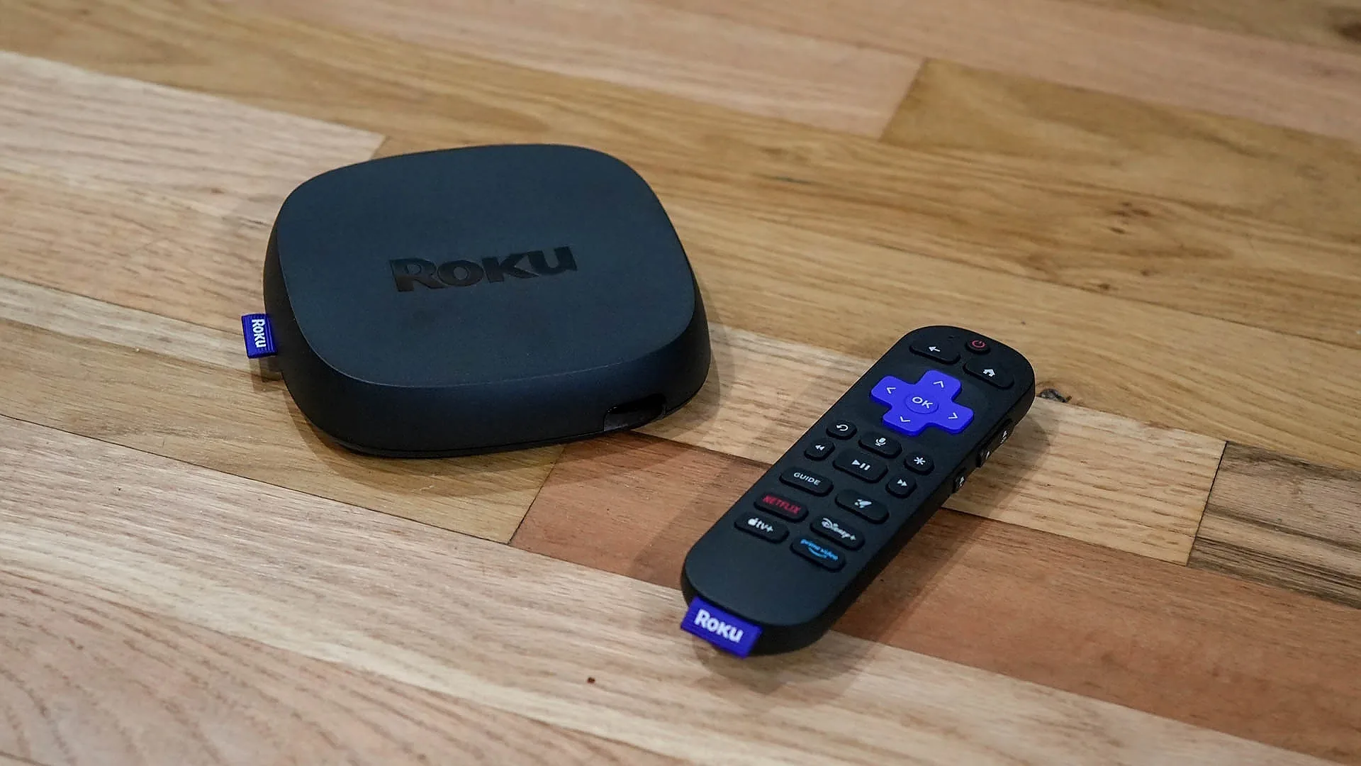 Roku streaming device and remote on a wooden surface